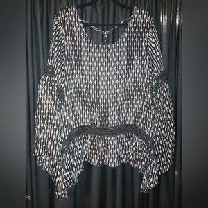 Laurie Felt top with lace accents. Criss cross back and shark bite hem